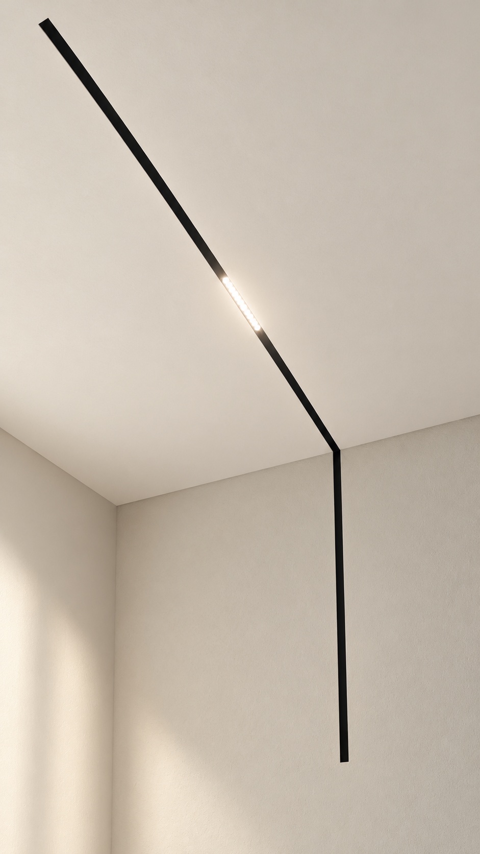 Rail d’éclairage noir avec retour mur-plafond